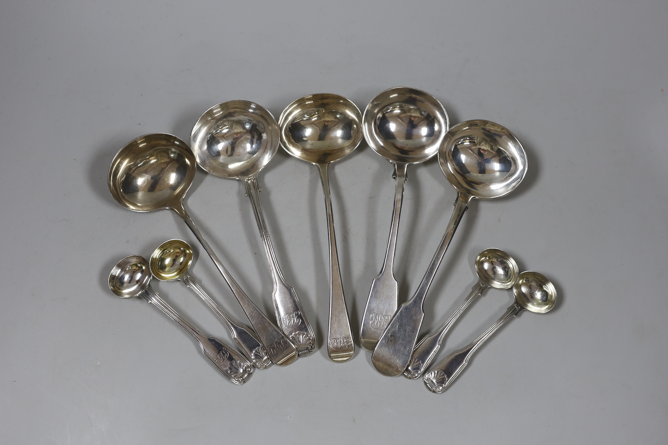 Five assorted George III and later silver sauce ladles, various patterns, dates and makers and four late George III fiddle, thread and shell mustard ladles, 12.1oz.